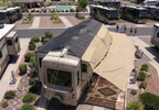 RV 5th wheel parked in  New Mexico RV park covered with hovershade canopy system with dual colored shade