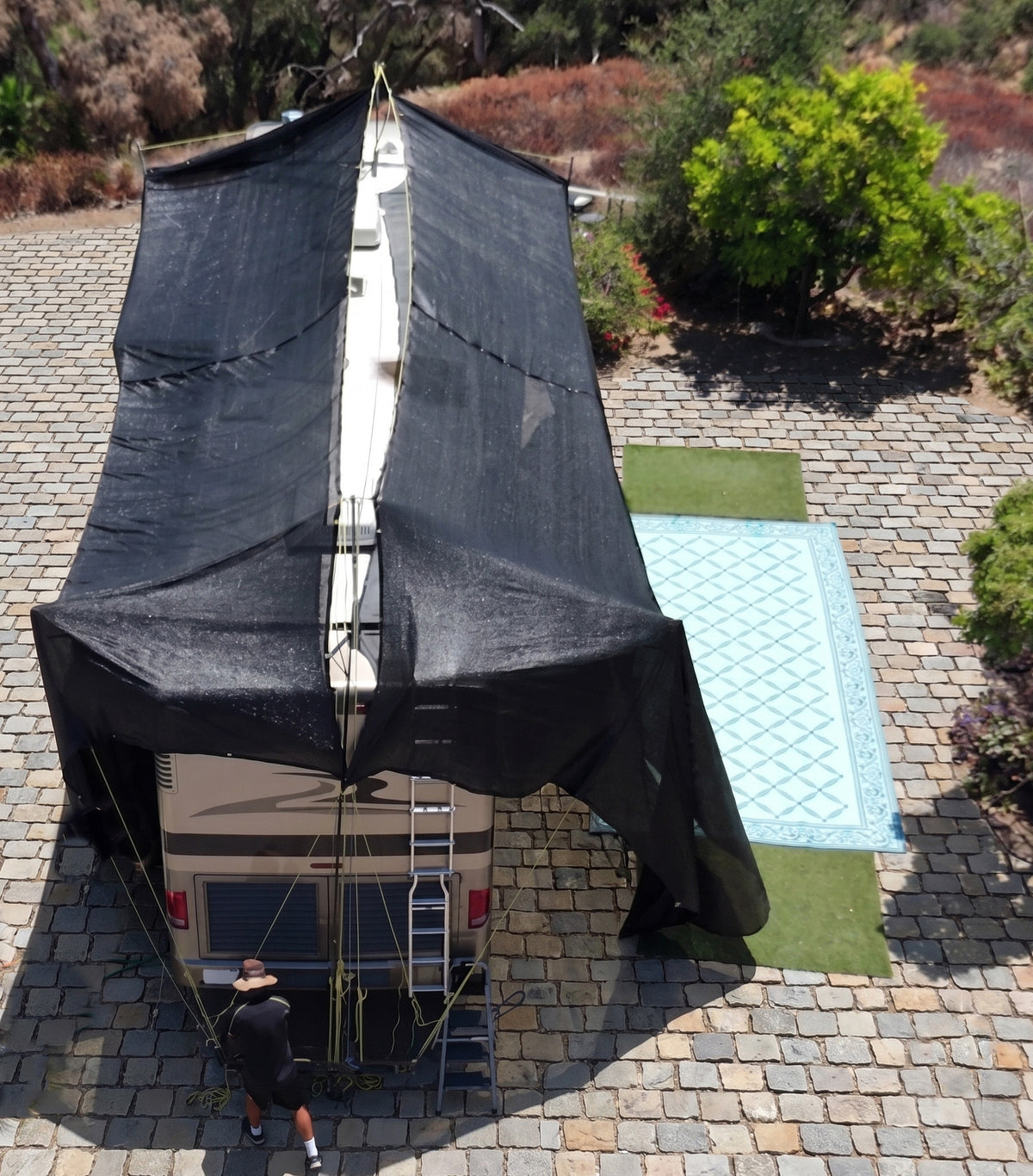 Hovershade™ Portable Modular RV CarPort frame and  shade fabric secured to roof of 40-foot RV — rear angle view fully shaded closed shade