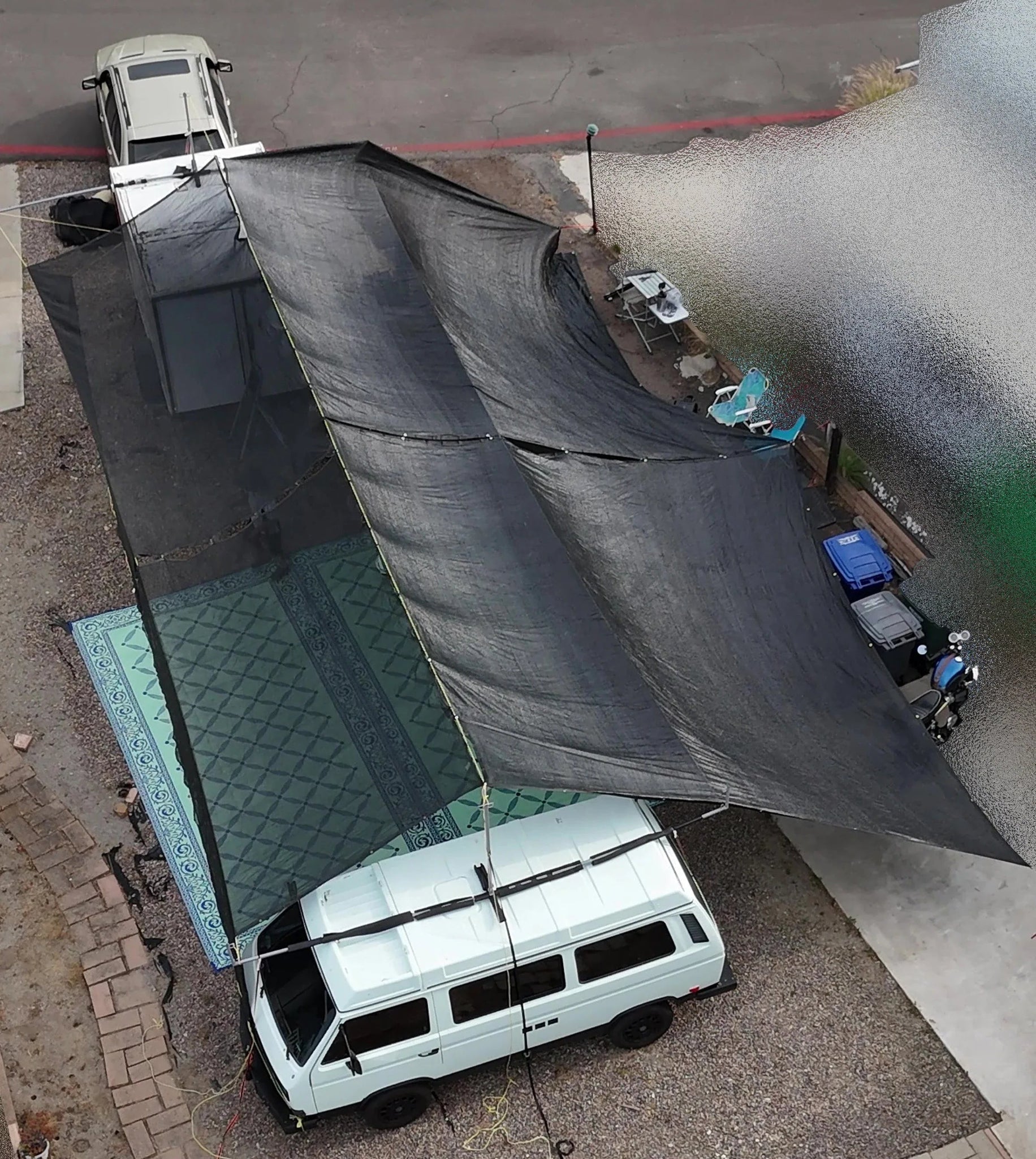 Hovershade™ breezeway setup between an SUV and camping trailer for outdoor living