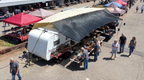 Hovershade setup as a sales tent between two vehicles in swap meet