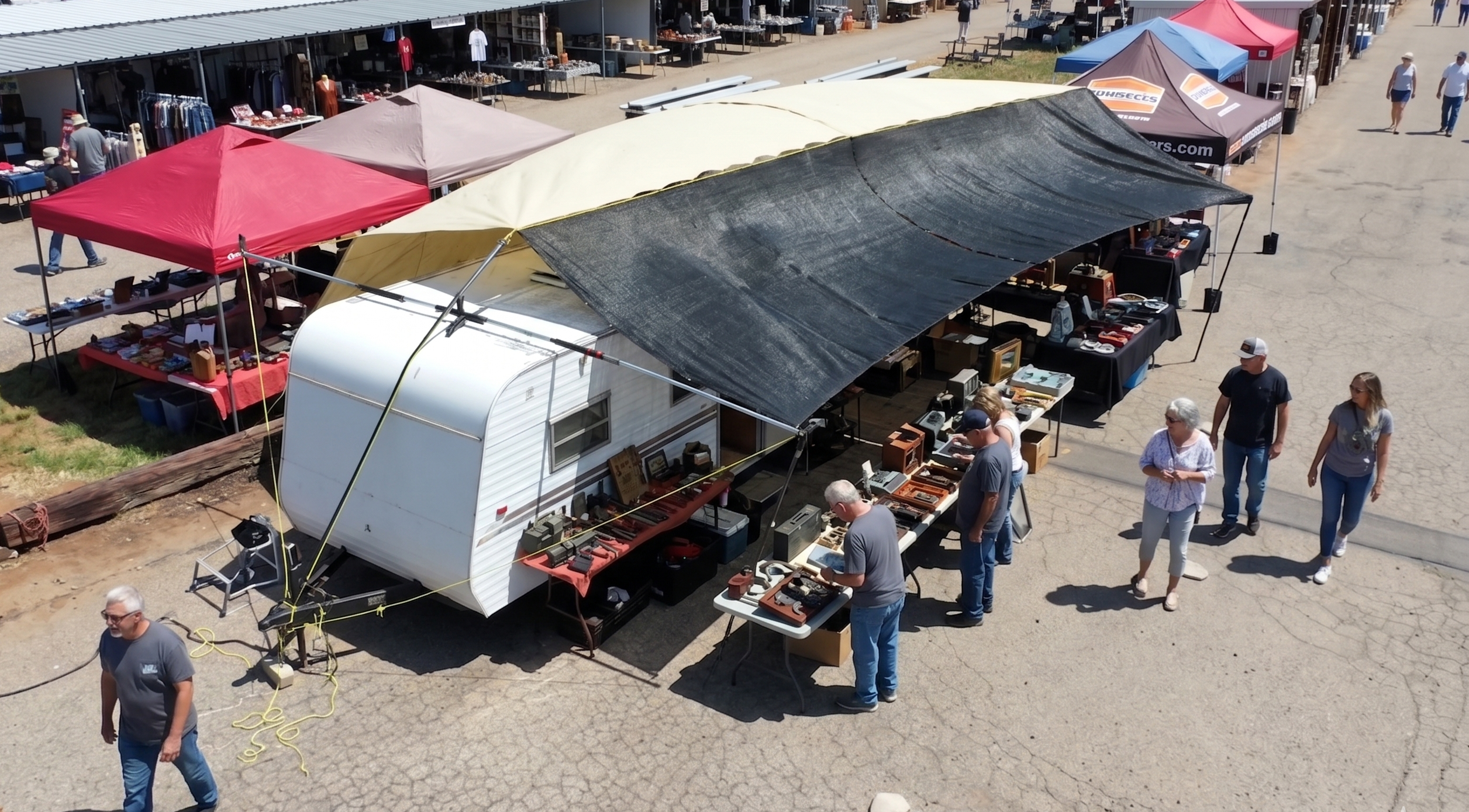 Hovershade setup as a sales tent between two vehicles in swap meet