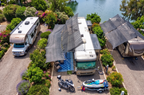 Hovershade shade frame canopy deployed on two RVs on the lake