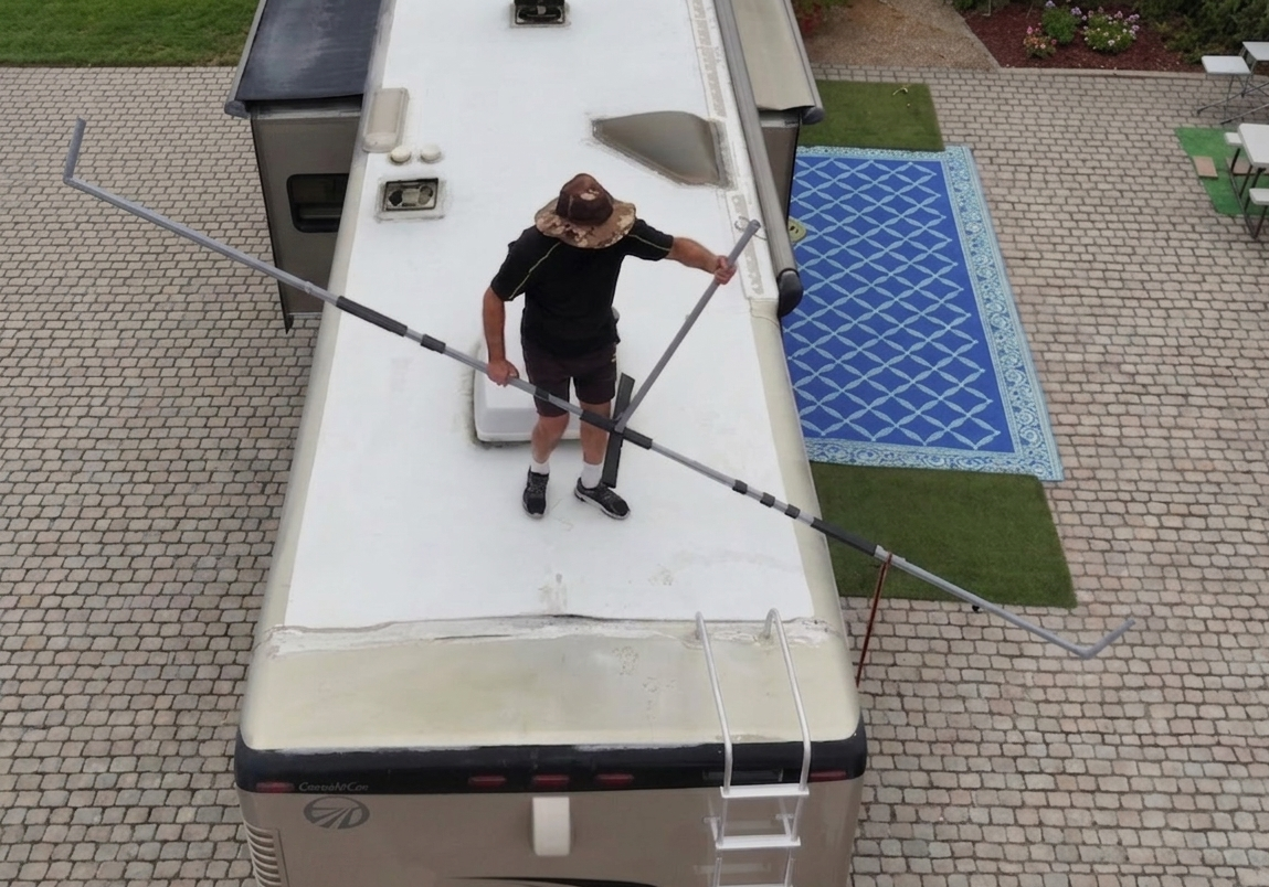 Massive shade fabric attached to hovershade frame canopy on a 40 foot RV retracted and pulled back like a curtain